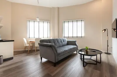 a living room with a couch and a table at Wesley Hotel in Bukit Mertajam