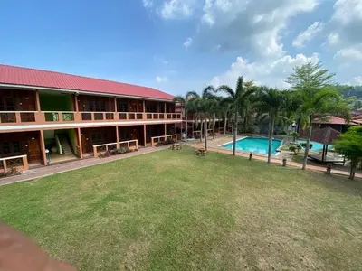 a resort with a large yard and a swimming pool at PANGKOR PURNAMA CHALET in Pangkor