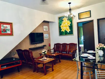 a living room with a couch and a table at Sinar Ara homestay in Lunas