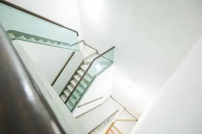 a staircase in a house with glass at Barrington Villa @ Golden Hill in Cameron Highlands