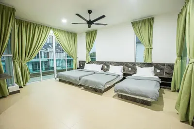 a bedroom with two beds and a ceiling fan at Barrington Villa @ Golden Hill in Cameron Highlands