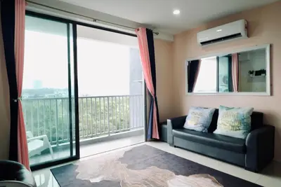 a living room with a couch and a large window at Haaniy Homestay Casa Kayangan Meru in Ipoh