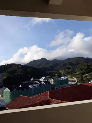 a view of a city with mountains in the background at Merlin Home@Crown Imperial Court in Tanah Rata