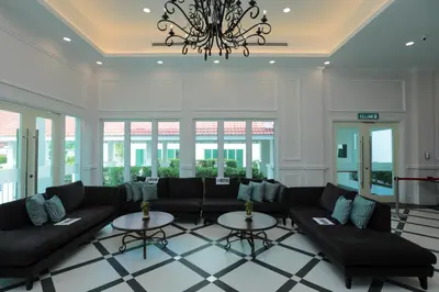 a living room with a couch and two tables at Hotel Casuarina@Kuala Kangsar in Kuala Kangsar