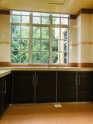 a kitchen with a sink and a large window at 3 Rooms Apt @ Crown Imperial Court in Cameron Highlands