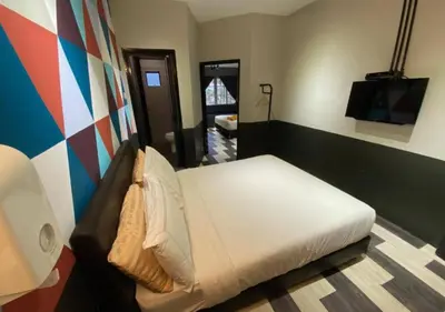 a bedroom with a bed and a tv in it at Kavy Boutique Hotel @ KBH in Brinchang