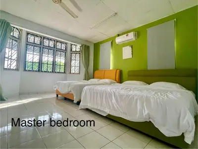 three beds in a room with green walls at 4B12B 20 pax Corner House in Ipoh