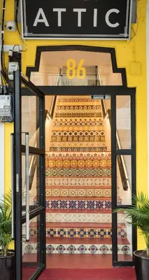 a glass table in front of an entrance to a store at Attic Hotel in George Town