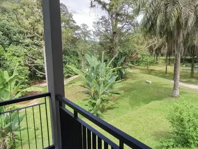 a balcony with a view of a yard at Sementra Hot Spring Nature Resort in Gopeng