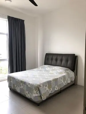 a bed sitting in a room with azeb at Barrington Square 2 Rooms Apartment at Golden Hill Night Market in Brinchang