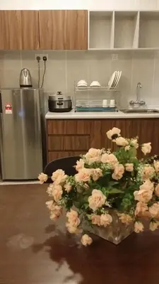 a bunch of flowers sitting on a table in a kitchen at Barrington Square 2 Rooms Apartment at Golden Hill Night Market in Brinchang