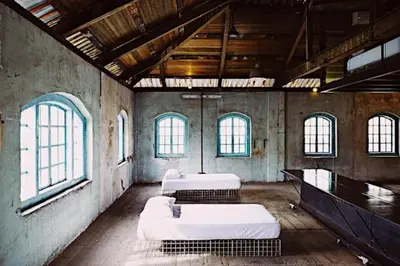 a room with four beds in it with windows at Belakang KongHeng By DreamScape in Ipoh