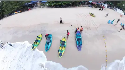 a group of people standing in the snow next to kayaks at Deluxe VIP Seaview Batu Ferringhi 1503 - 3 Rooms in Batu Ferringhi