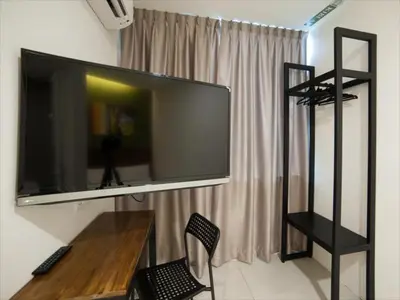 a large flat screen tv hanging on a wall at Econtel Queensbay in Bayan Lepas