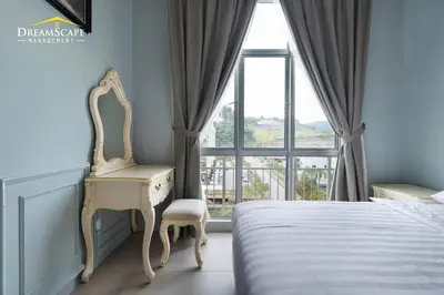 a bedroom with a desk and a bed with a window at Zetter Suites by Dreamscape in Cameron Highlands