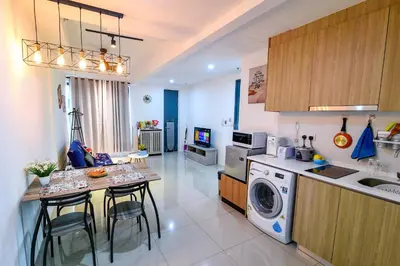 a kitchen with a washing machine and a table with chairs at Tropicana 218 Georgetown #31 \u7121\u6575\u6d77\u666f \u4e00\u623f\u4e00\u5ef3\u5f0fMax.6pax in George Town