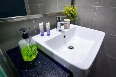 a white sink in a bathroom with a mirror at Tropicana 218 Georgetown #31 \u7121\u6575\u6d77\u666f \u4e00\u623f\u4e00\u5ef3\u5f0fMax.6pax in George Town
