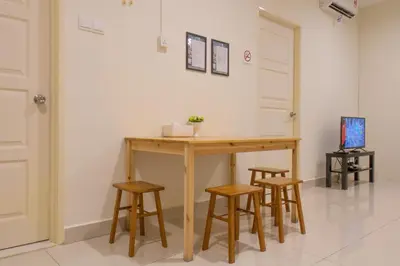 a wooden table with four stools in a room at Profolio @ Mansion One in George Town