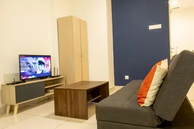 a living room with a couch and a television at Profolio @ Mansion One in George Town