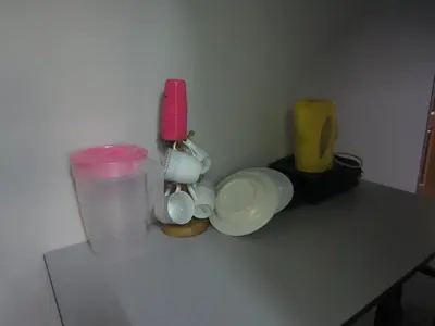 a counter top with cups and a blender and a container at Happy Owl in Ipoh