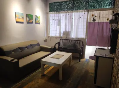 a living room with a couch and a coffee table at LUNAS DIY HOMESTAY in Lunas