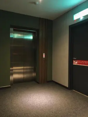 an elevator in a building with a sign on the door at The Gallivant Hotel in George Town