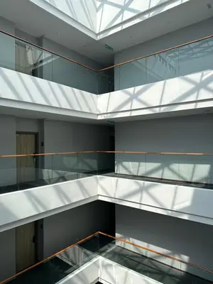 a glass staircase in a building with a glass ceiling at The Gallivant Hotel in George Town