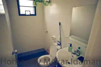 a small bathroom with a toilet and a sink at homestay mekar idaman in Kepala Batas