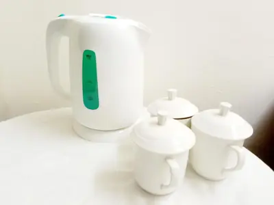a white blender sitting on top of a counter with three cups at MN Ferringhi Inn in Batu Ferringhi