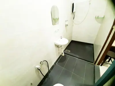 a white bathroom with a sink and a mirror at MN Ferringhi Inn in Batu Ferringhi