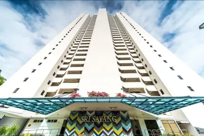 a tall white building with a sign on it at Pantai Seaview Resort Batu Ferringhi 1801 - 3 Rooms in Batu Ferringhi
