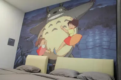 a bedroom with a mural of a boy and a girl at Bricks Terrace House 4R 3BR (Near to Night Market) in Brinchang