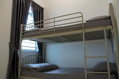 two bunk beds in a room with a window at Bricks Terrace House 4R 3BR (Near to Night Market) in Brinchang