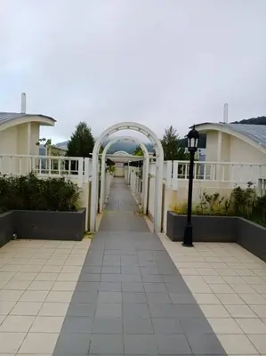 a walkway with an arch in the middle of a building at Bishops Cap at Cameron Highlands in Brinchang