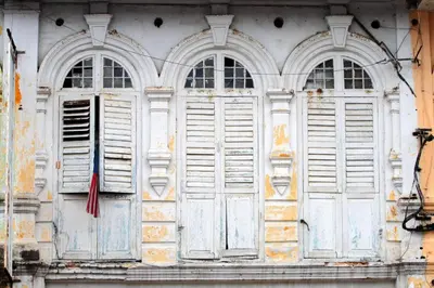 an old building with white doors and windows at URBANSTAY AT IPOH (STANDARD ROOM) in Ipoh