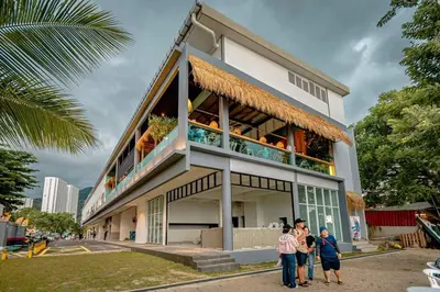 a group of people standing in front of a building at VIP Seaview Resort Batu Ferringhi 2104 - 2 Rooms in Batu Ferringhi