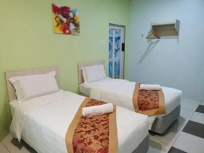 a room with two beds and a window at LH Hotel Langkap Perak in Kampung Degong