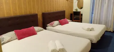 two beds sitting next to each other in a room at Hotel Tropicanna Pulai Point in Ipoh