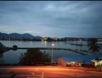 a view of a large body of water at night at Marina Height Seaview Resort, Teluk Batik, Lumut in Kampong Tebing Rabak