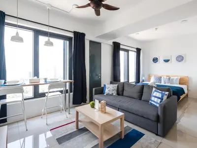 a living room with a couch and a bed at MUJI B&W Studio - Seaview at 218 Tropicana NEAR Komtar Food Heaven with Netflix & TV Box in George Town