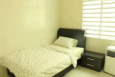 a small bedroom with a bed and a window at NEW SEAVIEW Cozy Modern Beach House in Tanjung Bungah