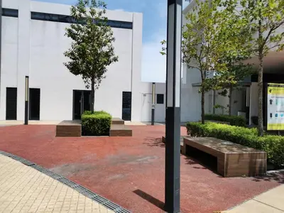 a building with a bench in a courtyard at Entire Condominium @ Woodsburry Butterworth Penang in Butterworth