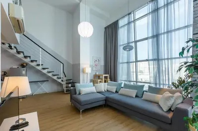 a living room with a blue couch and large windows at Maritime in George Town