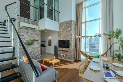 a living room with a couch and a table at Maritime in George Town