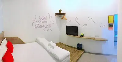 a room with a bed and a tv in it at Winggarden Murals House by JE Boutique Guesthouse in Ipoh