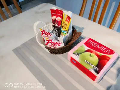a table with a basket of snacks and a basket of apples at Mcz homestay ipoh town 2room 7pax free wifi in Ipoh