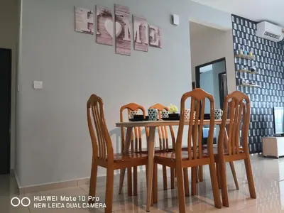 a dining room table with four chairs and a mirror at Mcz homestay ipoh town 2room 7pax free wifi in Ipoh