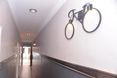a hallway with two lights on the wall at NICE STAY HOTEL in Raub