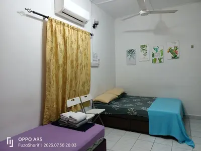 a bedroom with a bed and a yellow curtain at FAFA ROOMSTAY TANJUNG MALIM in Tanjung Malim