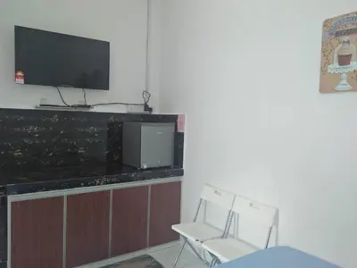 a living room with two chairs and a television at FAFA ROOMSTAY TANJUNG MALIM in Tanjung Malim